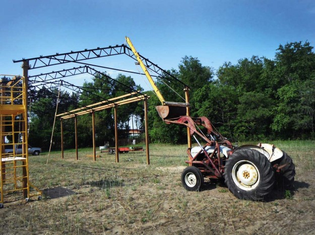 Pole barn with an 8N truss boom setting trusses